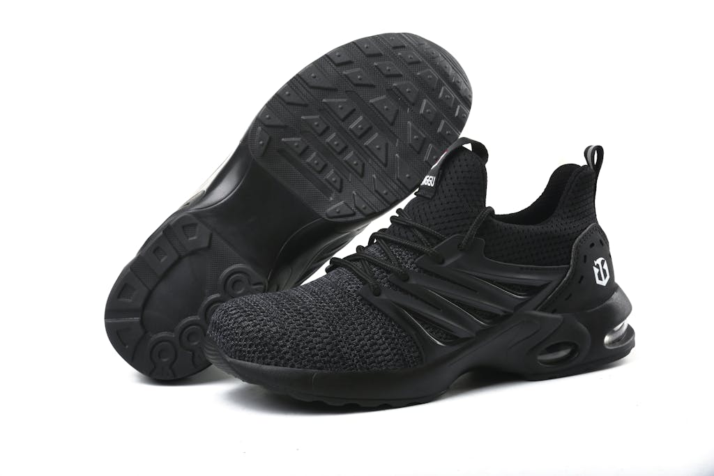 Stylish black running sneakers showcased on a minimalistic white background.